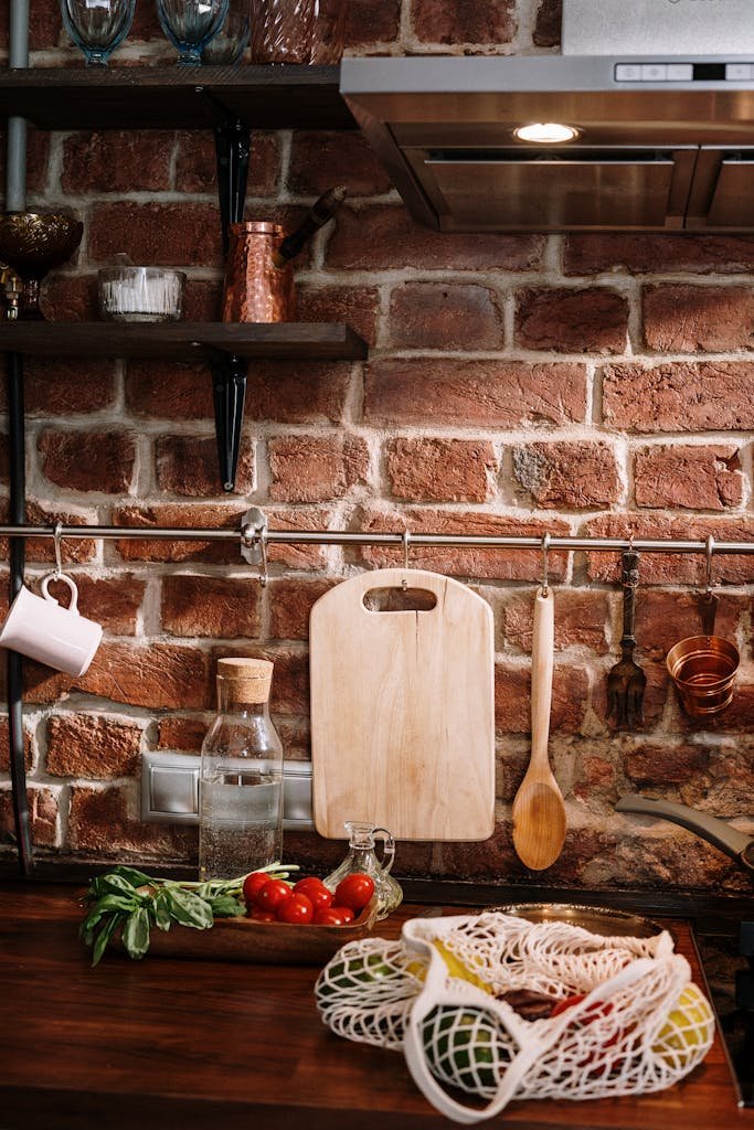 Cozy kitchen setting with chopping board, vegetables, and a brick wall background.